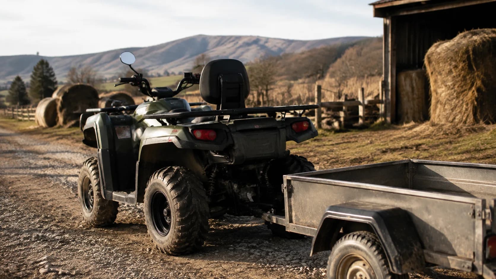 ATV utilitar cu remorcă goală pe un drum rural de pietriș